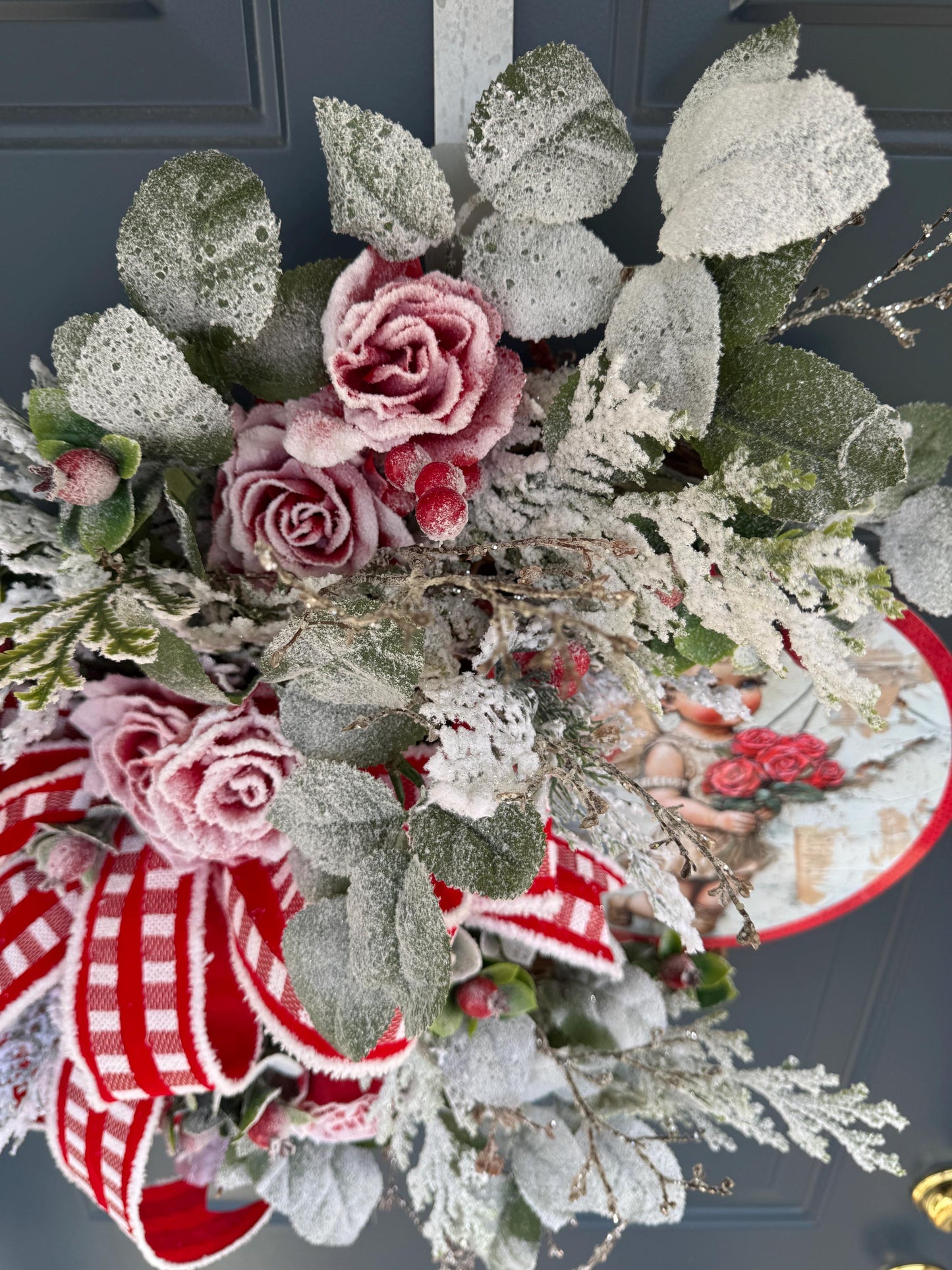 Romantic Valentines Wreath with Cherub Cupid Featuring Snowy Red Roses and Greenery