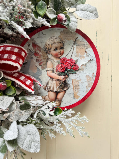Romantic Valentines Wreath with Cherub Cupid Featuring Snowy Red Roses and Greenery