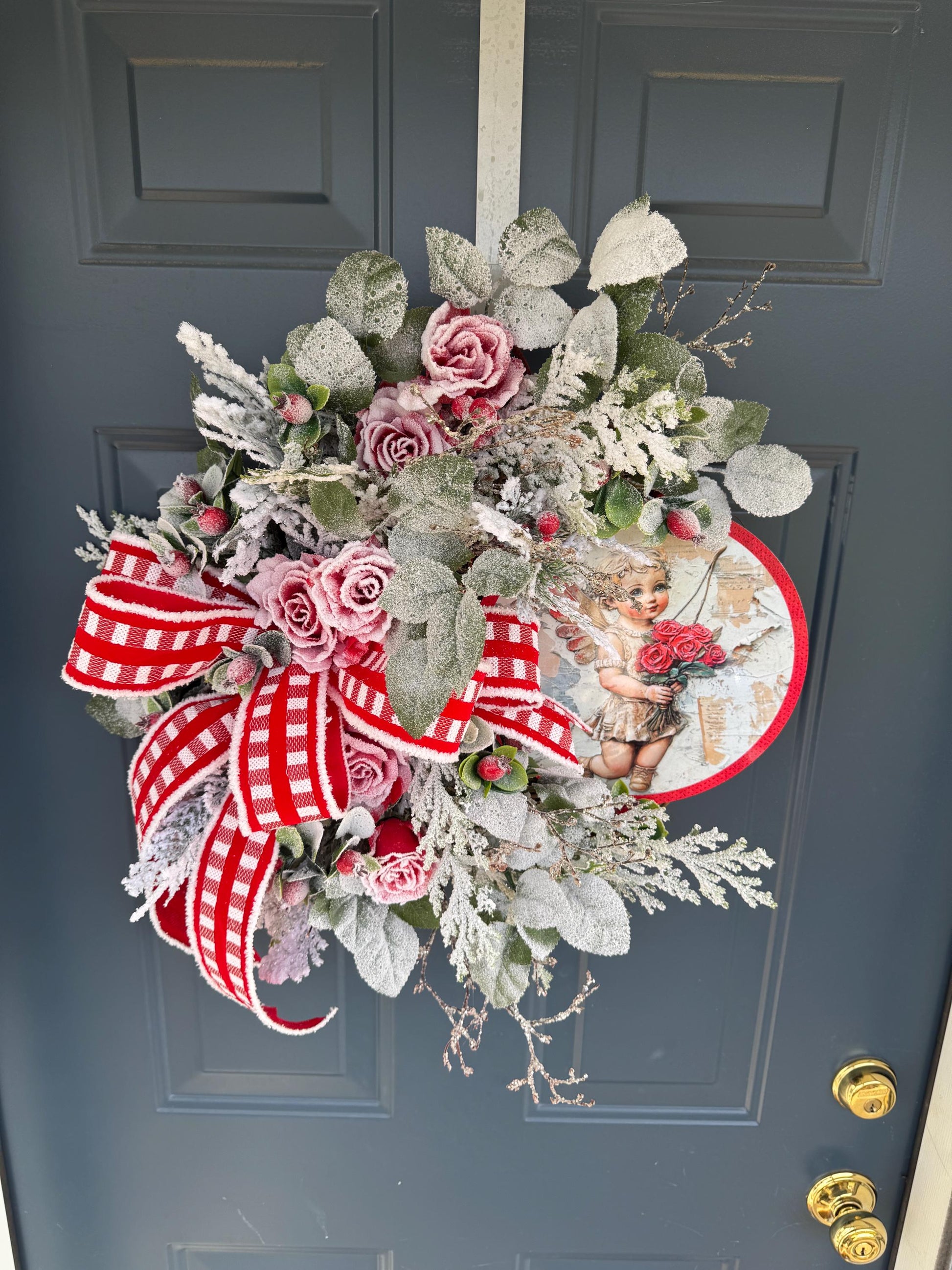Romantic Valentines Wreath with Cherub Cupid Featuring Snowy Red Roses and Greenery