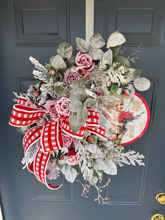 Romantic Valentines Wreath with Cherub Cupid Featuring Snowy Red Roses and Greenery